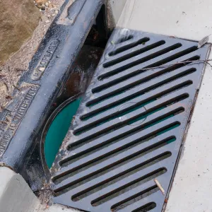 Rainwater entering a storm drain leading to the Pritzlaff Conservation Center bioswale