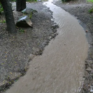 Stormwater flowing down Canyon Trail past Campbell Bridge