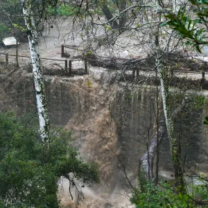 Mission Creek cresting Mission Dam during rainstorm