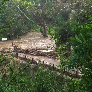 Debris accumulation at Mission Dam during rainstorm
