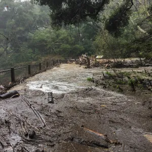 Debris accumulation at Mission Dam during rainstorm