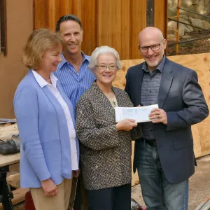 Linda Mathews, Chair of the Teahouse Improvements Fundraising Committee, gives Steve Windhager donations totaling $8,000 from the tea house volunteers to launch the fundraising for the repairs and improvements of the Teahouse and Tea Garden in 2017-2018