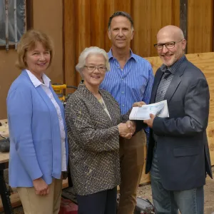 Linda Mathews, Chair of the Teahouse Improvements Fundraising Committee, gives Steve Windhager donations totaling $8,000 from the tea house volunteers to launch the fundraising for the repairs and improvements of the Teahouse and Tea Garden in 2017-2018