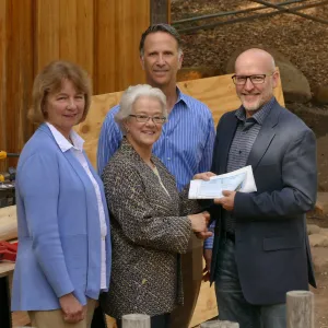 Linda Mathews, Chair of the Teahouse Improvements Fundraising Committee, gives Steve Windhager donations totaling $8,000 from the tea house volunteers to launch the fundraising for the repairs and improvements of the Teahouse and Tea Garden in 2017-2018