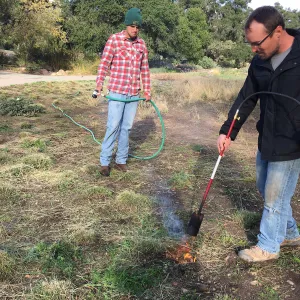 Wes Franken and Nick Resler using a torch for weed abatement