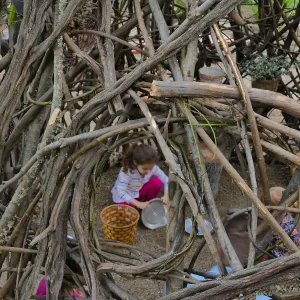 Santa Barbara Botanic Garden Casitas Opening, child playing in the â€œWoodrat Houseâ€ Casita