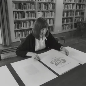 Nancy Hawver in Blaksley Library examining Henry Evans portfolio