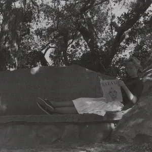 woman reading a magazine on Bissell Bench, stone bench