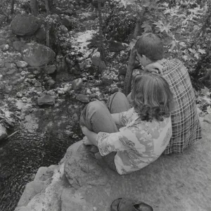 visitor couple sitting on top of old Mission Dam