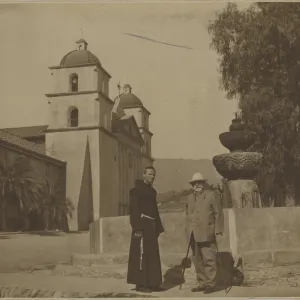 E.O. Orpet with Franciscan in front of Mission