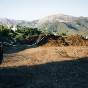 Geege Ostroff at mulch pile on ridge above Hort Unit that caught on fire and was removed