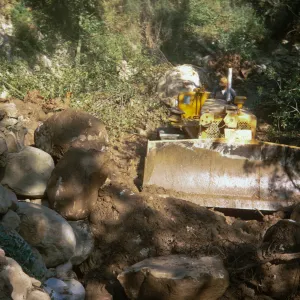 bulldozer repair to bank erosion of Mission Creek below the Guild House