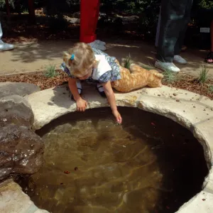 girl at frog pond, Home Demonstration Garden Dedication