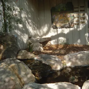 Mosaic on Information Kiosk, stone bench and pond