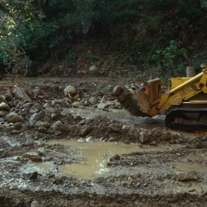 Mission Creek flooded above Mission Dam, with a bulldozer