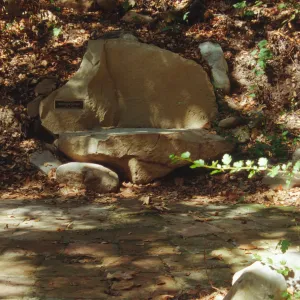 new stone bench with plaque, on west side of Mission Dam, exposed tiles
