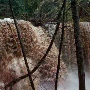 Water flowing over Mission Dam, Spring 1978